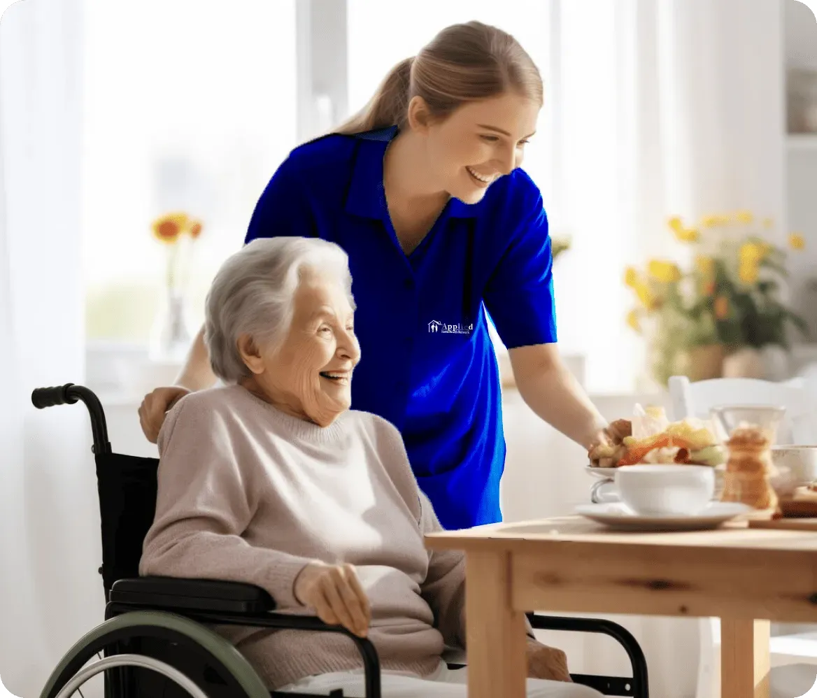 A nurse dressed in blue helps an elderly woman in a wheelchair, exemplifying kindness and support in their exchange.