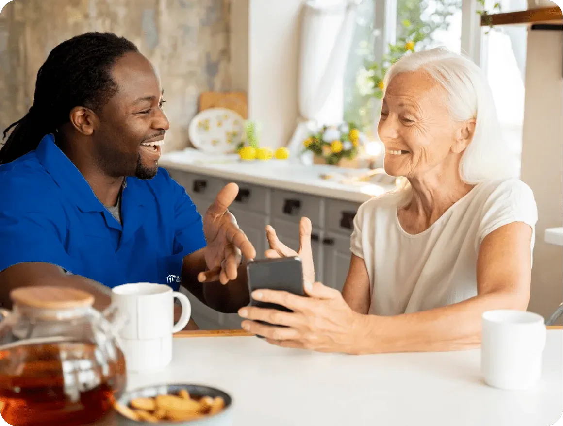 nurse and elderly woman laughing