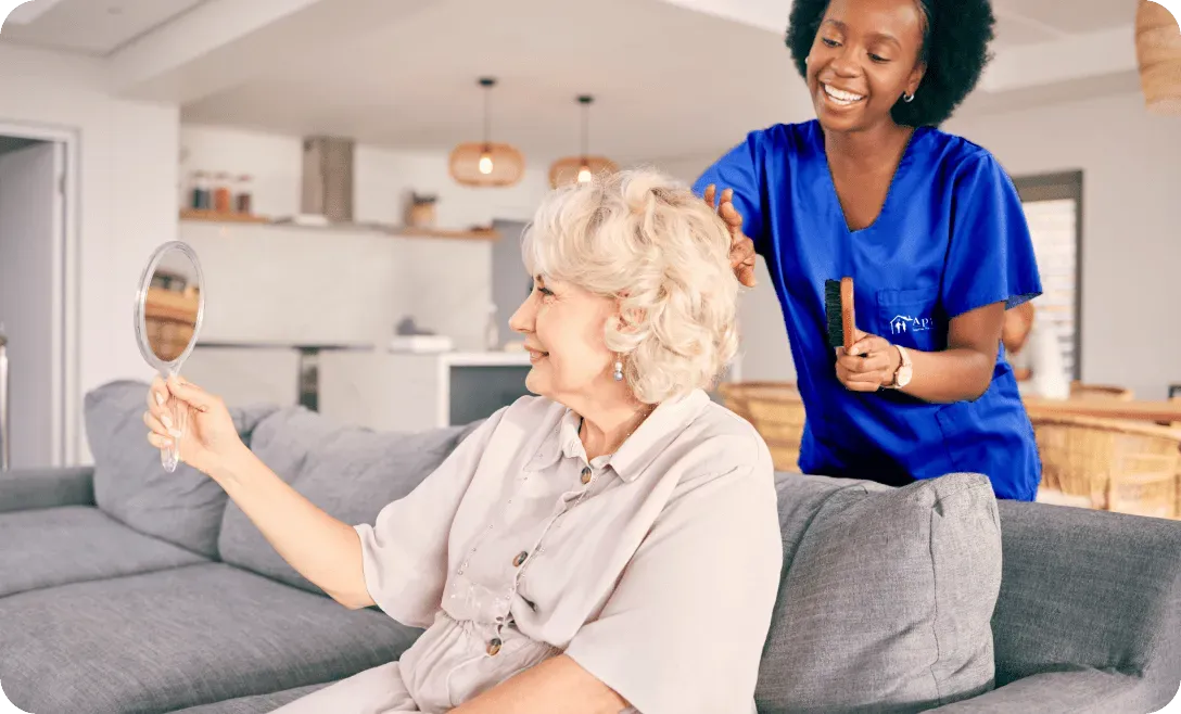 nurse combing elderly lady's hair