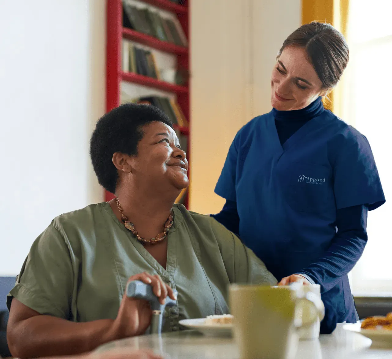 nurse conversing wioth elderly woman