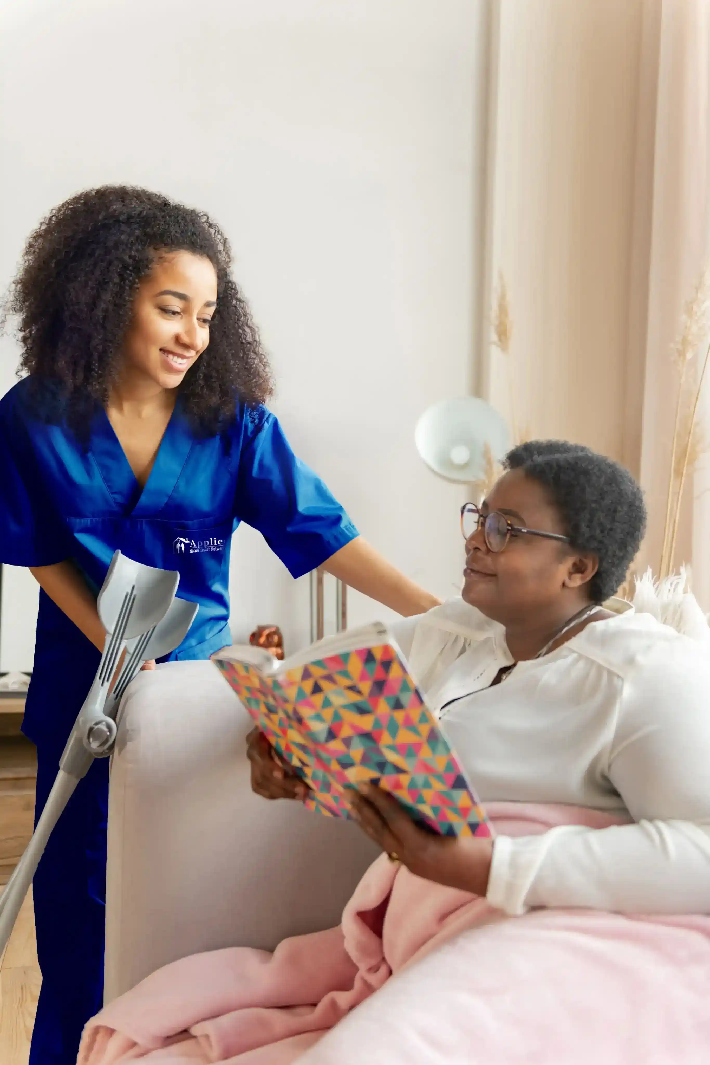 nurse offering an elderly lady breakfast he has made for her