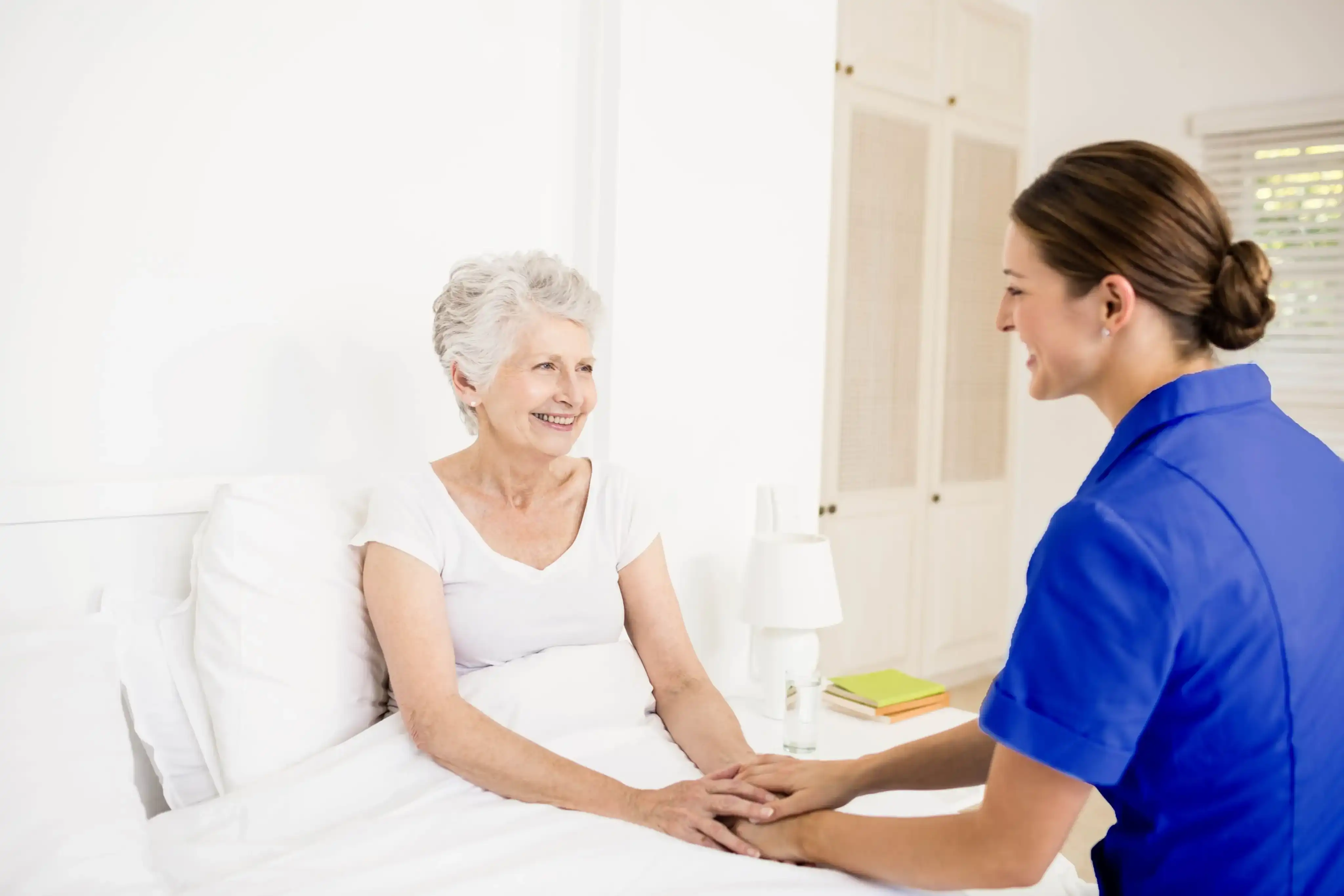 our nurse and elderly woman  holding hands