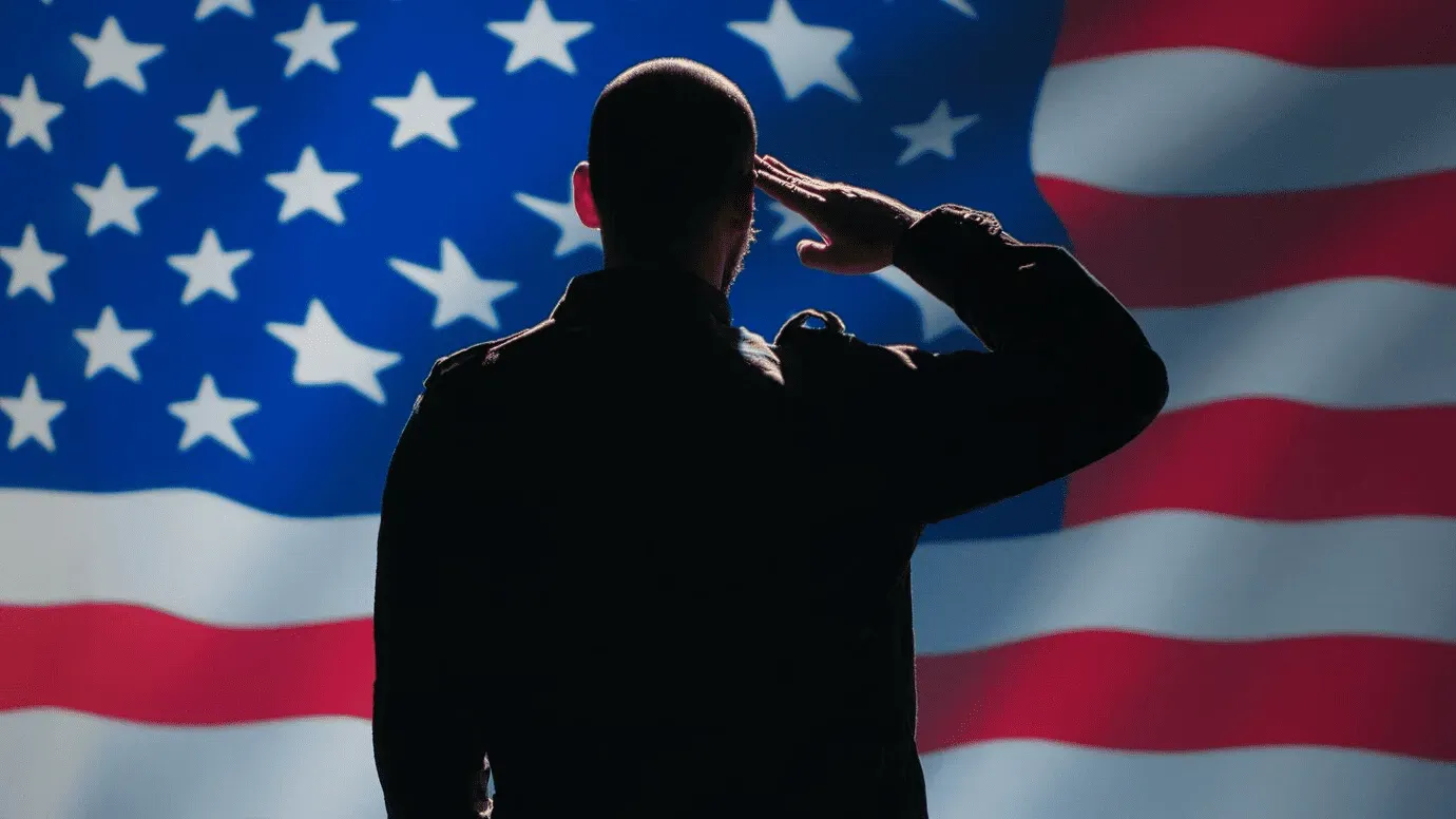 man saluting us flag